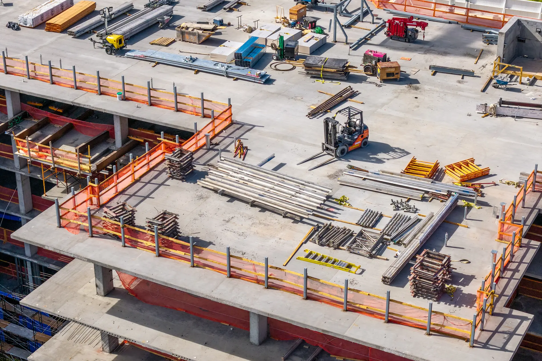 Forklift and staged shoring, joists and framing material on an upper deck