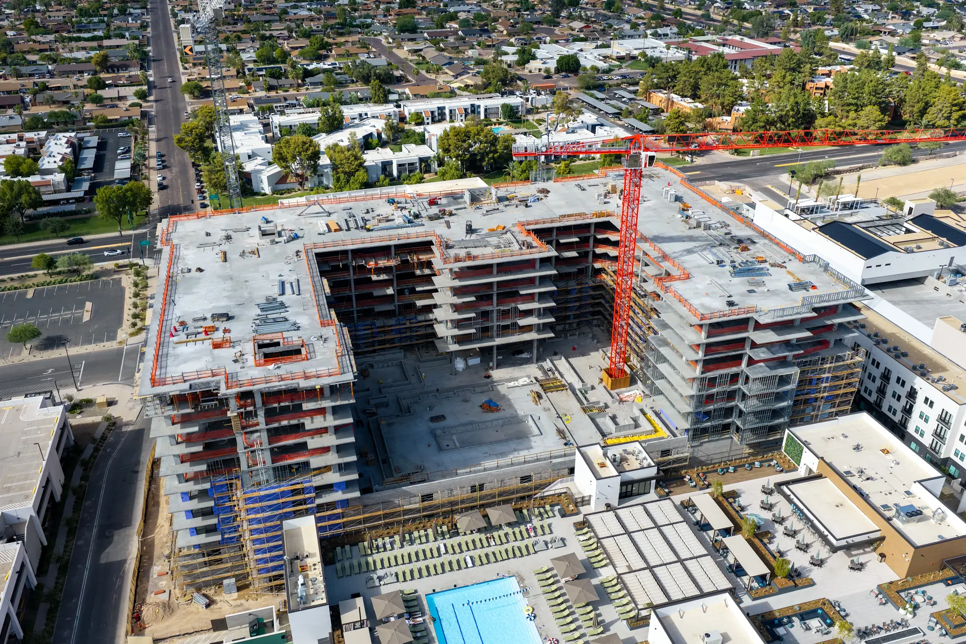Oblique aerial of the full construction site with surrounding streets and neighbouring buildings